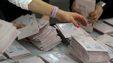 Volunteers prepare postal votes during the German national election in Munich, Germany, Sunday, Feb. 23, 2025