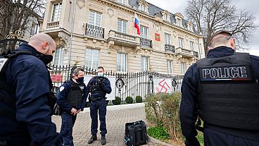 French police officers stand in front of the Russian consulate after it was tagged with swastikas in Strasbourg, eastern France, Friday Feb.25, 2022.