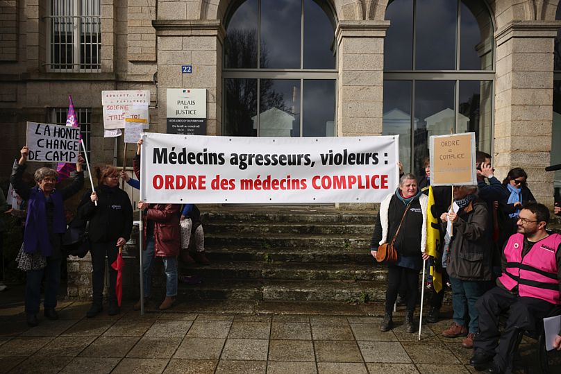 Protestors hold a banner reads: "Doctors, aggressors, rapists, French Medical Association accomplice" outside the Vannes courthouse, 24 February 2025.