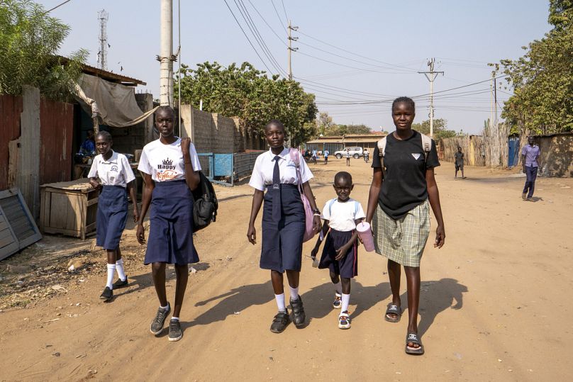 Schoolgirls walk back home after being turned away from their school due to an ongoing extreme heatwave in Juba, South Sudan. 