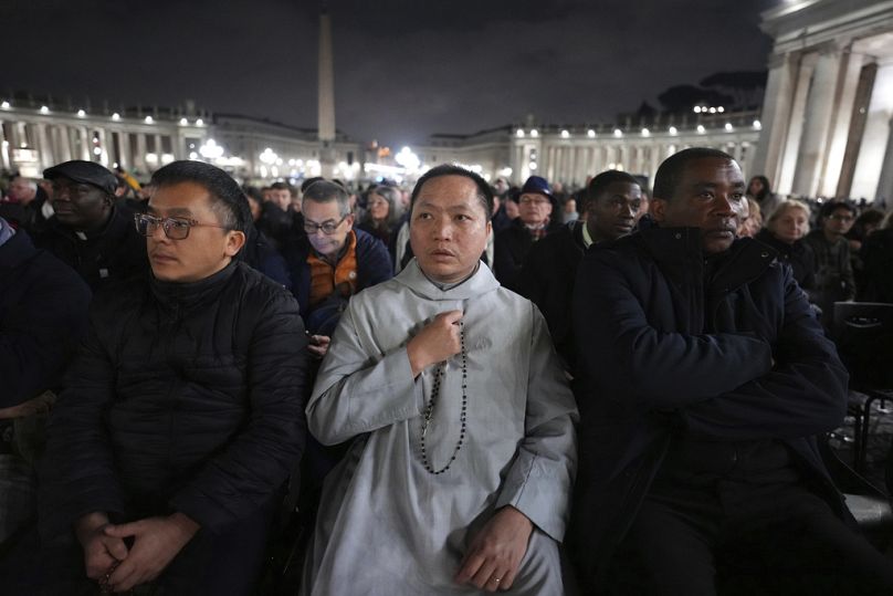 People attend a rosary prayer service with Cardinal Luis Antonio Tagle held for the health of Pope Francis in St Peter's Square at The Vatican, Tuesday, Feb. 25, 2025.