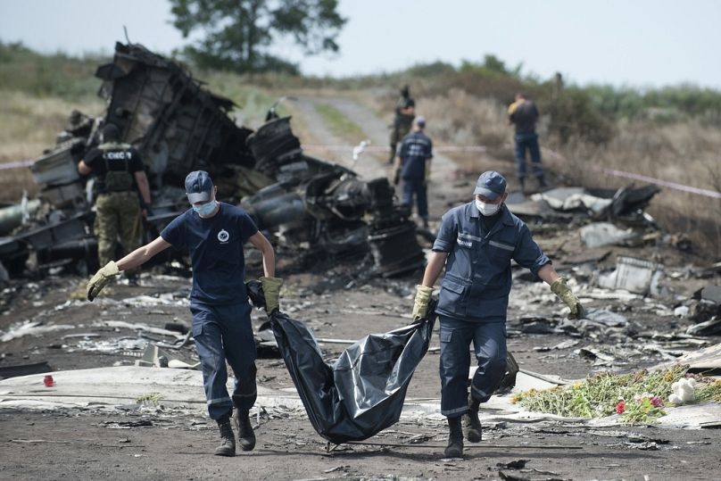 Gli operatori di emergenza ucraini trasportano il corpo di una vittima del volo MH17 della Malaysia Airlines