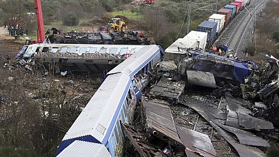 FILE - A crane, firefighters and rescuers operate after a collision, that killed 57 people, in Tempe, about 376 kilometres (235 miles) north of Athens