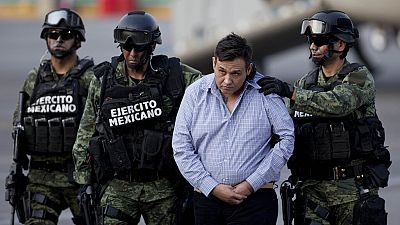 FILE - Soldiers escort a man who authorities identified as Omar Trevino Morales, alias "Z-42," leader of the Zetas drug cartel, in Mexico City, March 4, 2015