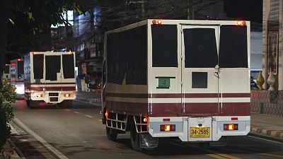 Trucks leave a detention centre in Bangkok, Thailand, on 27 February, 2025.