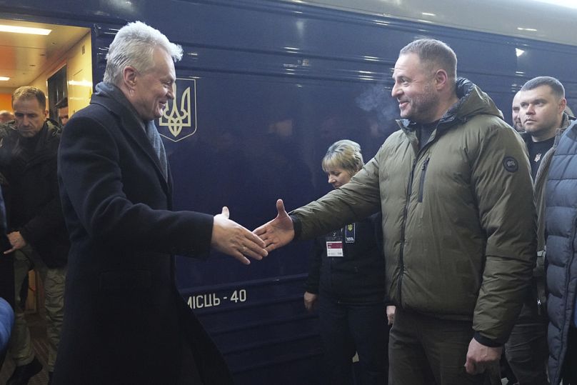 Lithuanian President Gitanas Nauseda, left, arrives at train station on the third anniversary of the Russian invasion of Ukraine, Kyiv, Ukraine, Monday, Feb. 24, 2025