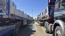 Trucks line up at the Egyptian side of the Rafah border crossing between Egypt and the Gaza Strip after Israel blocked the entry of aid trucks into Gaza, Sunday, March 2, 2025