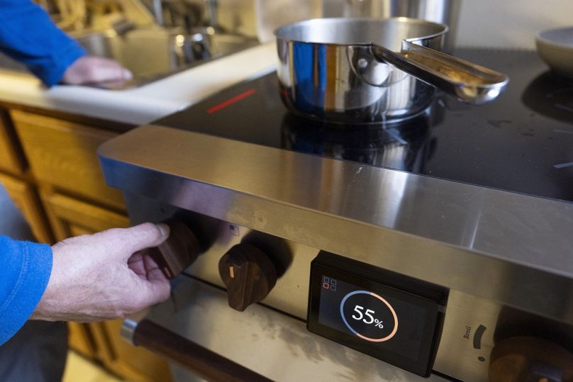 Yaker turns on his new electric stove in New York