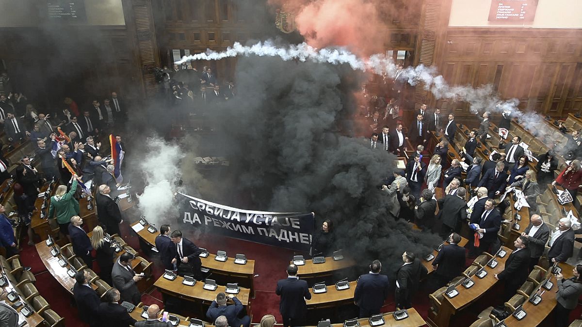 Serbia's parliament session erupts into chaos as opposition MPs set off flares and smoke grenades