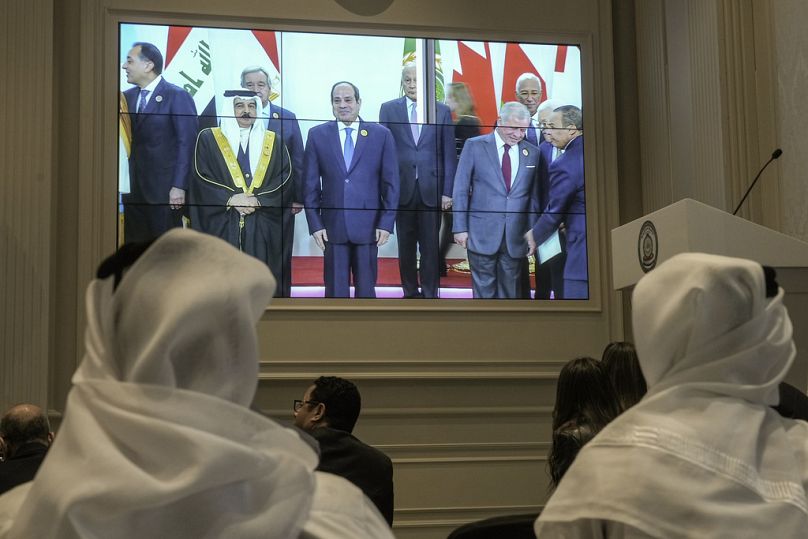 A screen displaying Egyptian President Abdel Fattah el-Sissi, center, with Arab Leaders, at the press center hall of the emergency Arab summit at Egypt's New Administrative Ca