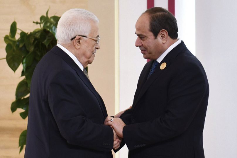  Egyptian President Abdel-Fattah el-Sissi, greets Palestinian Authority President Mahmoud Abbas, during the emergency Arab summit at Egypt's New Administrative Capital