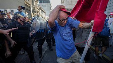 A demonstrator holds his cap as riot police try to disperse protesters during a protest for better pensions for retirees in Buenos Aires, Argentina, Wednesday, March 5, 2025. A demonstrator holds his cap as riot police try to disperse protesters during a protest for better pensions for retirees in Buenos Aires, Argentina, Wednesday, March 5, 2025.