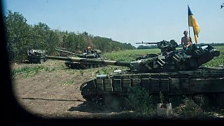 FILE - Ukrainian army tanks take their positions near Illovaisk, Donetsk region, eastern Ukraine, Aug. 14, 2014. 