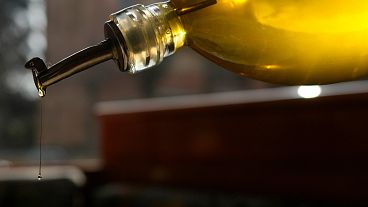 A person pours olive oil into a salad in Italy in March 2024. A person pours olive oil into a salad in Italy in March 2024.