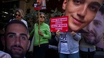 Demonstrators hold photos depicting the faces of Israeli hostages who are being held in the Gaza Strip, during a protest in Tel Aviv, Israel, Thursday, March 6, 2025. 