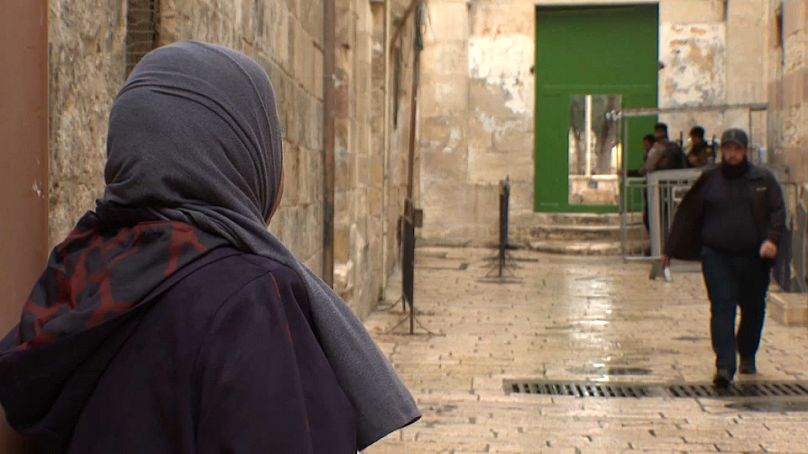 المقدسية عايدة الصيداوي الصادر بحقها الإبعاد عن الأقصى وهي تنظر  إلى الشرطة الإسرائيلية