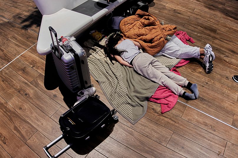 Stranded passengers rest at the airport in Frankfurt, Germany Monday 10 March. 