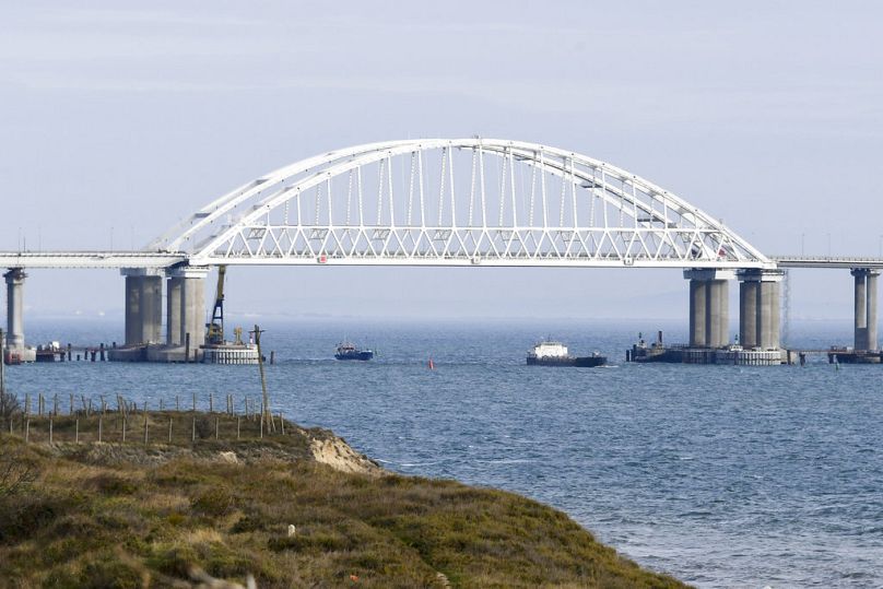 Ships make way near to the Kerch bridge, in background, near in to Kerch, Crimea, Monday, Nov. 26, 2018. 