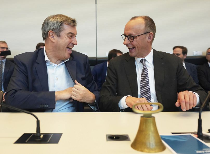 Friedrich Merz, leader of the CDU, and Markus Soeder, CSU party chairman, attend the constituent meeting of the new parliamentary group in the Bundestag, February 2025