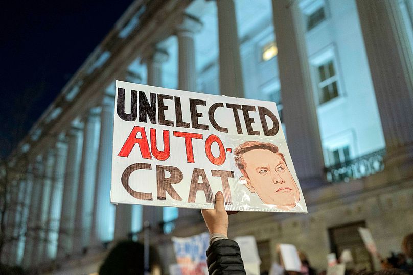 People protest during a rally against Elon Musk outside the Treasury Department in Washington -  4 Feb. 2025