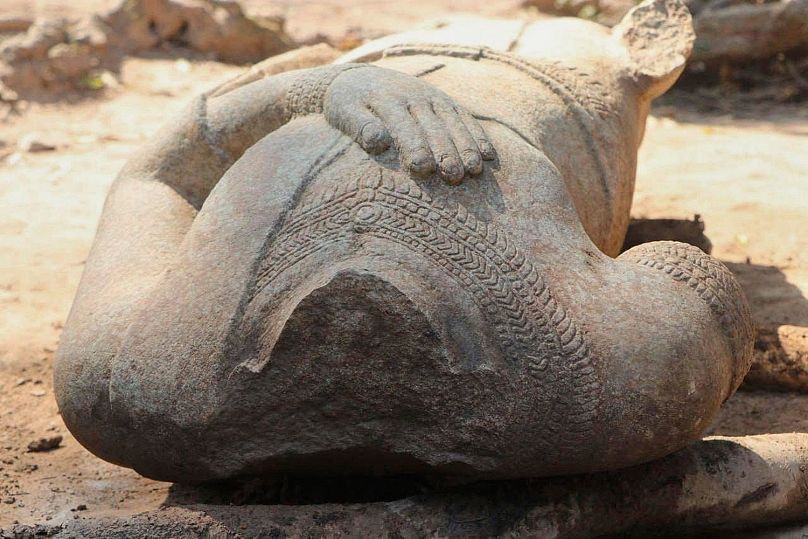 Headless statue excavated by archaeologists at the Angkor temple complex in Cambodia's Siem Reap province