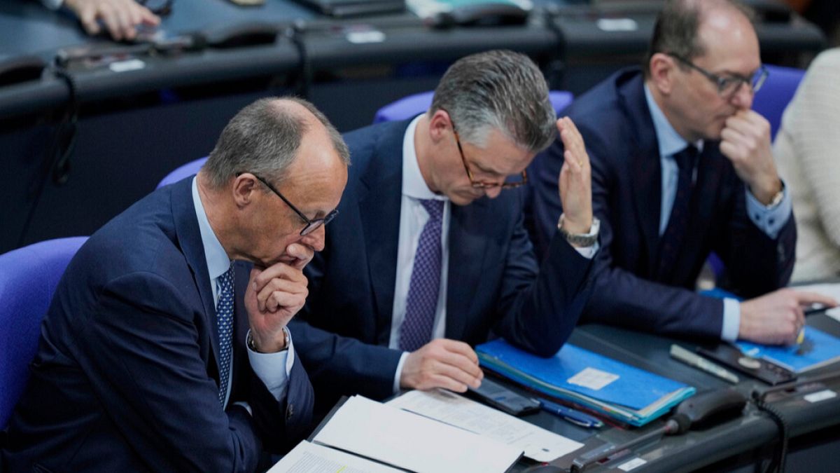 Christian Democratic Union party chairman Friedrich Merz sits next to lawmakers Thorsten Frei, and Alexander Dobrint, during Thursday, March 13, 2025.