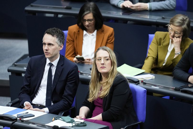 Green Party co-faction leader Kathrin Droege, center, sits between other lawmakers during a meeting of the German federal parliament, Bundestag, Thursday, March 13, 2025.