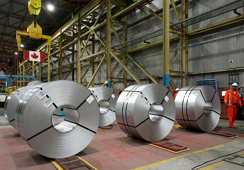 Steel workers work at the ArcelorMittal Dofasco steel plant in Hamilton, 12 March, 2025