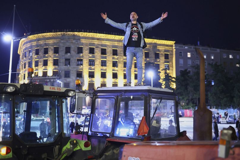 A protester yells from the top of a tractor ahead of a major rally this weekend in downtown Belgrade, Serbia, Friday, March 14, 2025