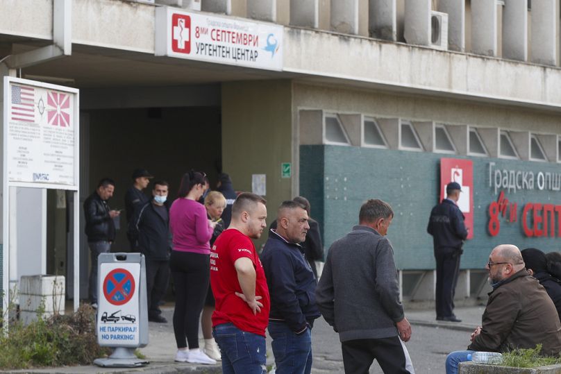 People wait in front of the hospital in the town of Kocani, North Macedonia, Sunday, March 16, 2025, after a massive fire in a nightclub. (AP Photo/Boris Grdanoski)