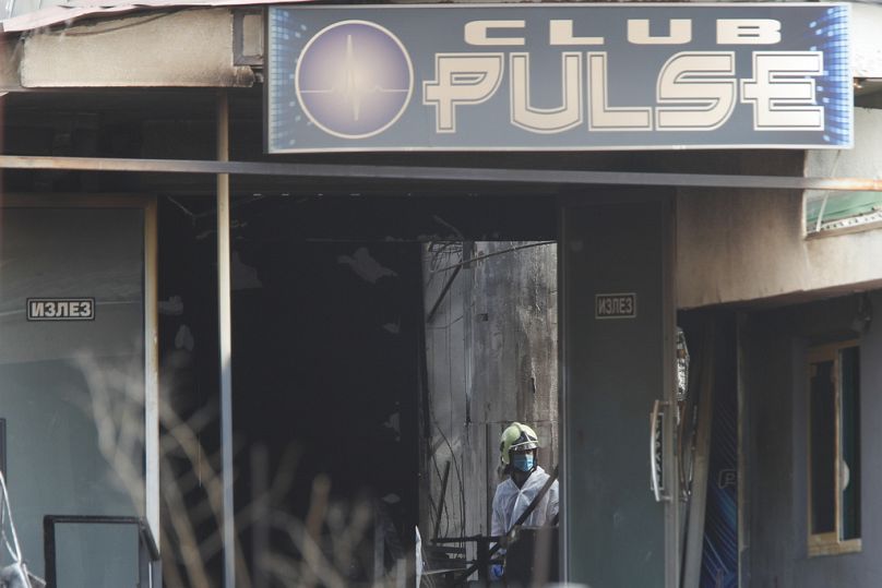 A firefighter inspects a nightclub after a massive fire in the town of Kocani, North Macedonia, Sunday, March 16, 2025. (AP Photo/Boris Grdanoski)