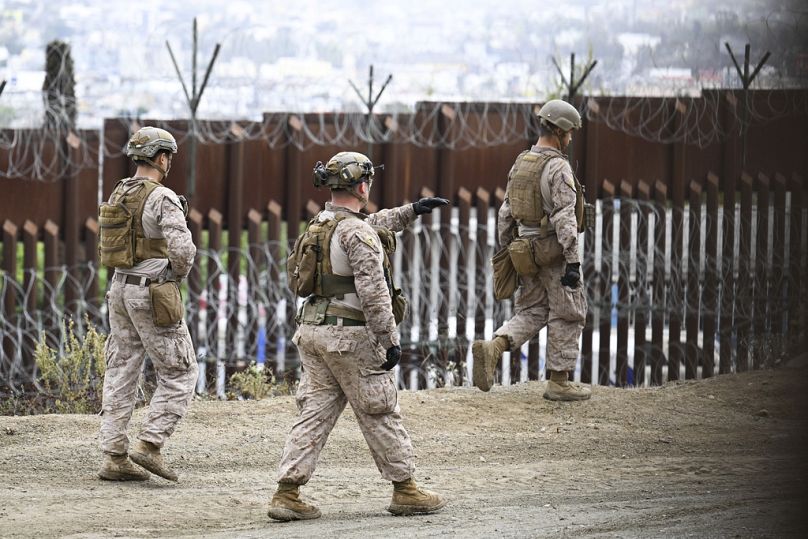 U.S. Marines deploy along the U.S.-Mexico border near the San Ysidro Port of Entry, Friday, Feb. 7, 2025, in San Diego with Tijuana, Mexico in the background.