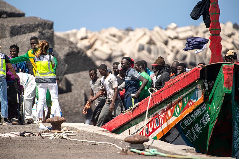 Migrants disembark from a wooden boat at the port in La Restinga on the Canary island of El Hierro, 18 August, 2024