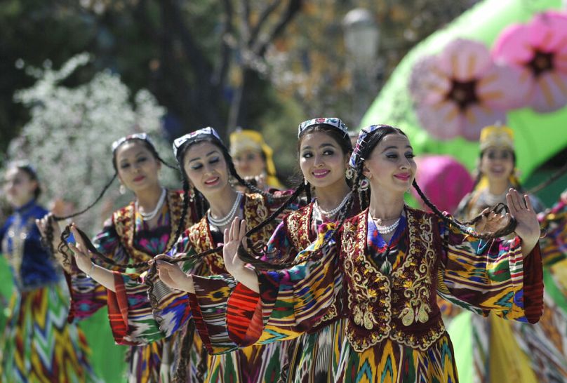 Uzbek girls in national costumes perform during festivities marking the holiday of Navruz in Tashkent, Uzbekistan, Saturday, March 21, 2009. 