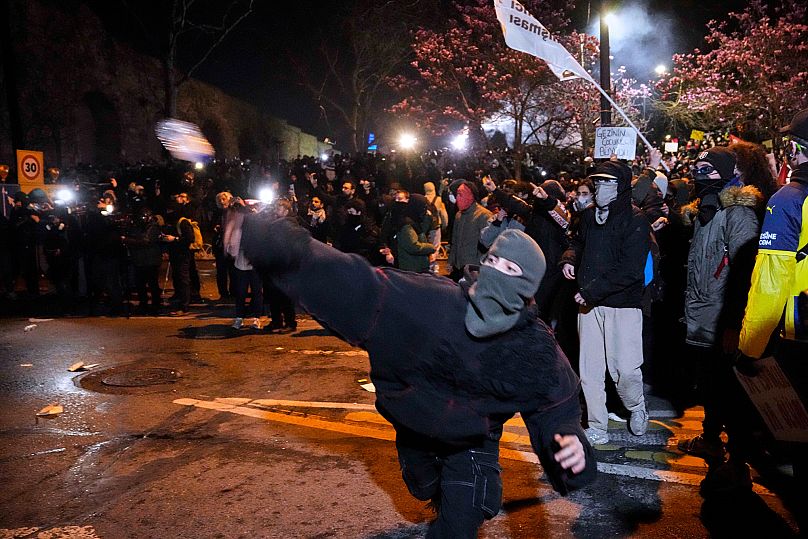 A man throws an object towards police during a protest against the arrest of Istanbul's Mayor in Istanbul, 21 March, 2025