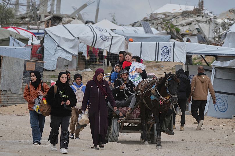 نازحون فلسطينيون يحملون أمتعتهم بعد تجدد الهجوم الإسرائيلي على قطاع غزة، على مشارف بيت لاهيا، الخميس، 20 مارس/آذار 2025