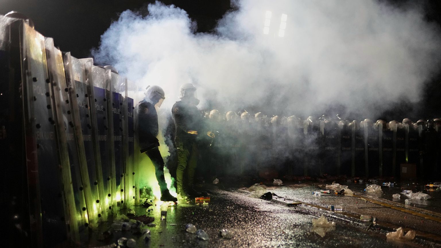 Fireworks thrown by protesters explode next to riot police during a protest after Istanbul's Mayor Ekrem Imamoglu was arrested and sent to prison, in Istanbul, Turkey, Sunday,
