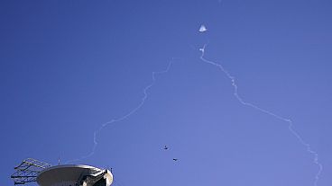 FILE - Israel's Iron Dome anti-missile system fires to intercept as air raid sirens sound in Tel Aviv, Wednesday, Oct. 23, 2024. (Nathan Howard/Pool Photo via AP)