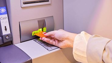 A person withdrawing money from an ATM