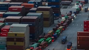 Trucks line up to depart from a container terminal in Nanjing in east China's Jiangsu province on Tuesday, April 8, 2025. 