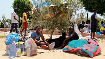 Migrants rest during a gathering in Sfax, 7 July, 2023