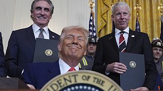 US Energy Secretary Chris Wright (R) and Interior Secretary Doug Burgum stands by as president Donald Trump signs his latest executive orders on 8 April 2025.