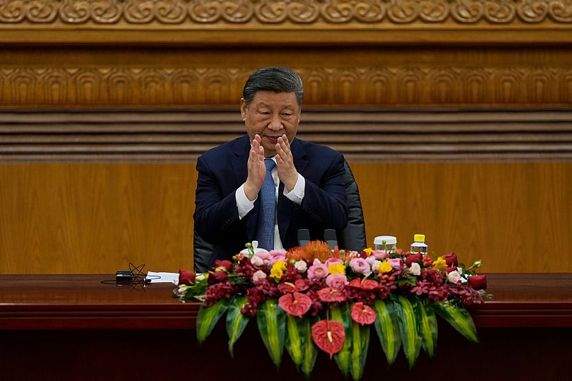 Prezydent Chin Xi Jinping bije brawo podczas spotkania z przedstawicielami międzynarodowego biznesu w Wielkiej Hali Ludowej w Pekinie. 