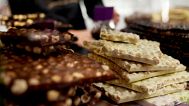 FILE: Chocolate bark is on display behind a glass counter of a shop in Bruges, 6 February 2025