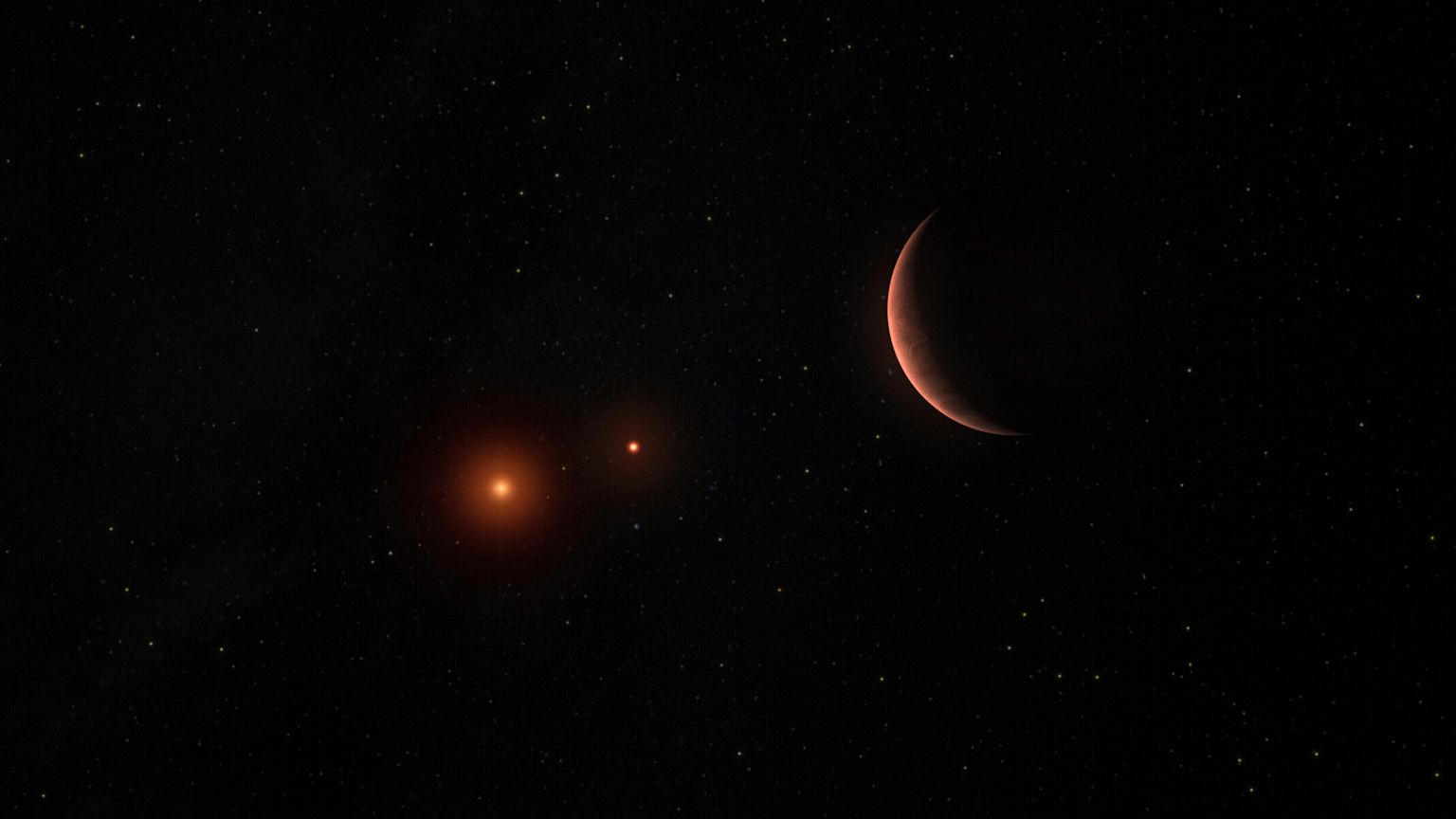 Cette illustration d'artiste fournie par l'Observatoire européen austral montre une exoplanète en orbite autour de deux naines brunes, des objets célestes plus légers que les étoiles.