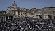 Faithful attend the Easter mass presided over by Cardinal Angelo Comastri in St. Peter's Square at the Vatican Sunday, April 20, 2025