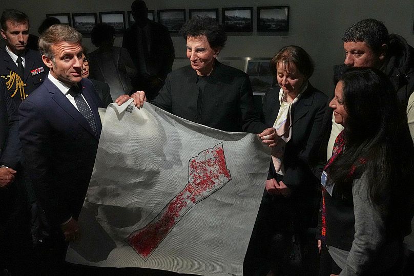 Emmanuel Macron et le directeur de l'Institut du monde arabe (IMA) Jack Lang tiennent une carte des territoires palestiniens lors de l'exposition "Trésors sauvés de Gaza"
