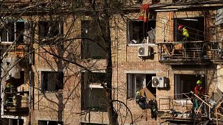 Rescue workers clear the rubble of a house damaged by a Russian strike on a residential neighbourhood in Kyiv, 24 April 2025