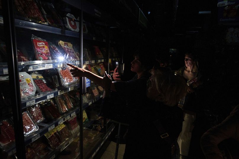 People buy food at a supermarket during a massive power outage in Pamplona, northern Spain, Monday, April 28, 2025