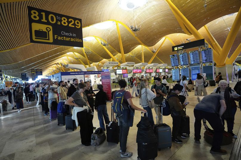 Passengers queue at Madrid airport, during a major power outage, Monday, April 28, 2025